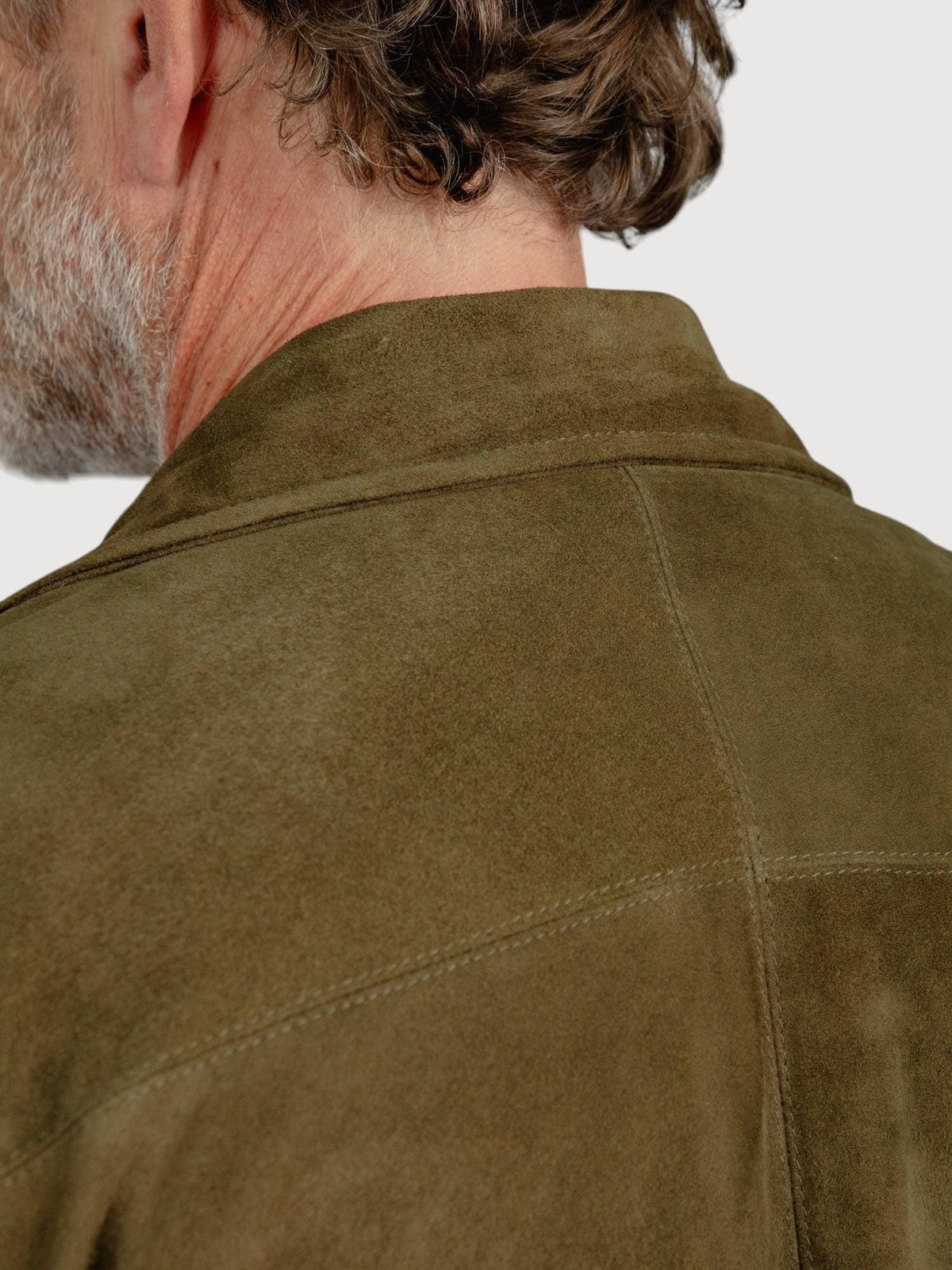 Luxequir Vogue moss green suede overshirt showing detailed back panel stitching and collar on a man