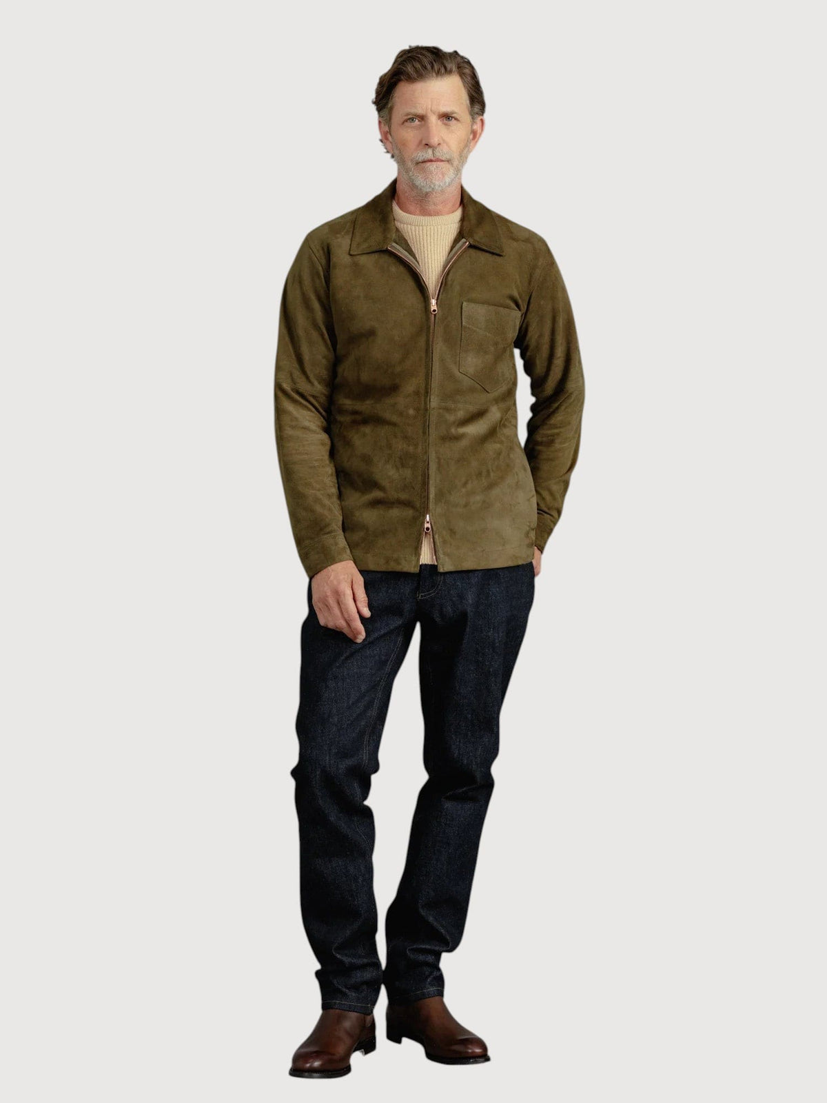 Luxequir Vogue moss green suede overshirt worn by a man with dark jeans and brown boots against a plain background