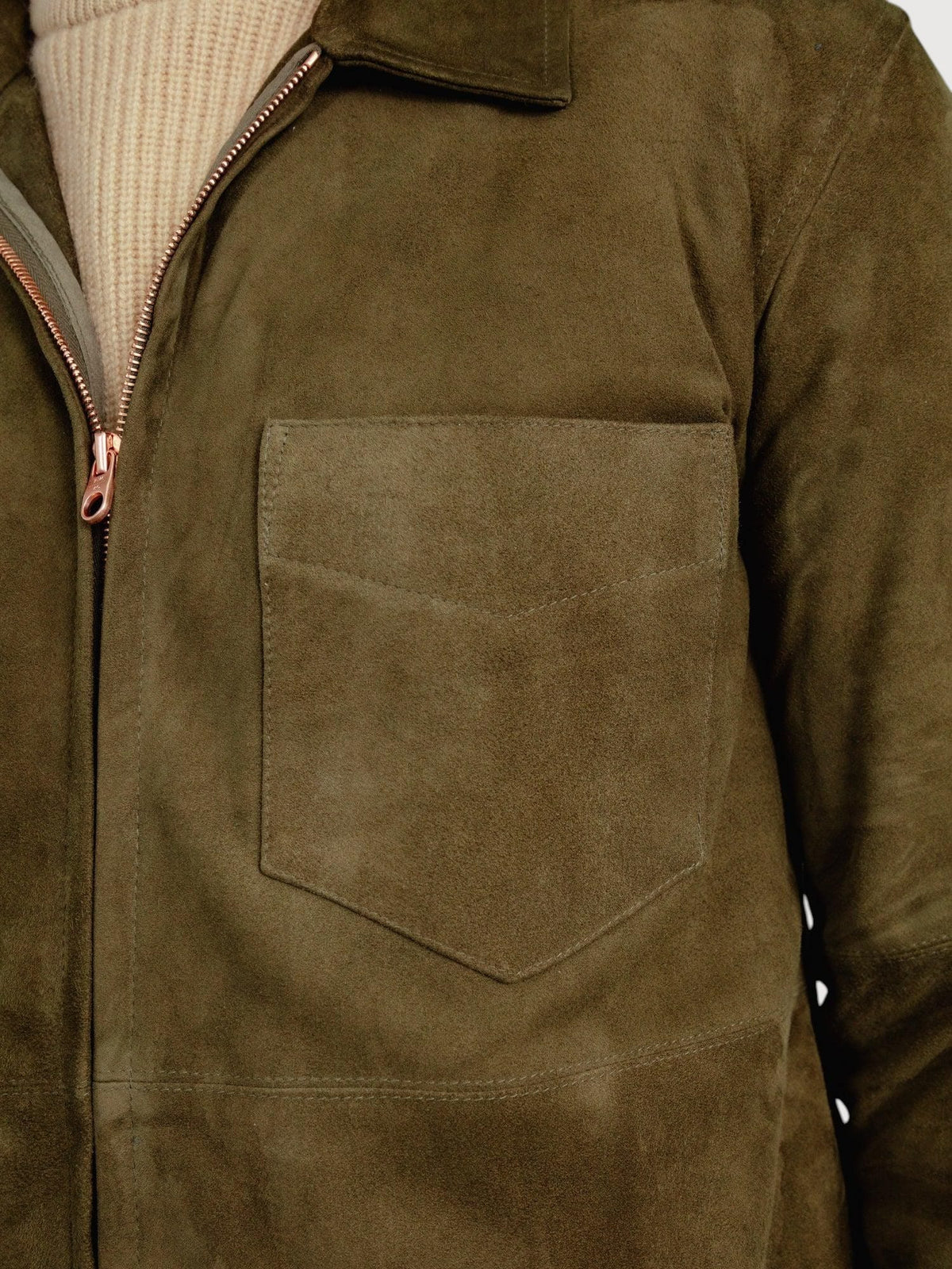 Luxequir Vogue moss green suede overshirt featuring a chest pocket and front zip closure over a beige sweater