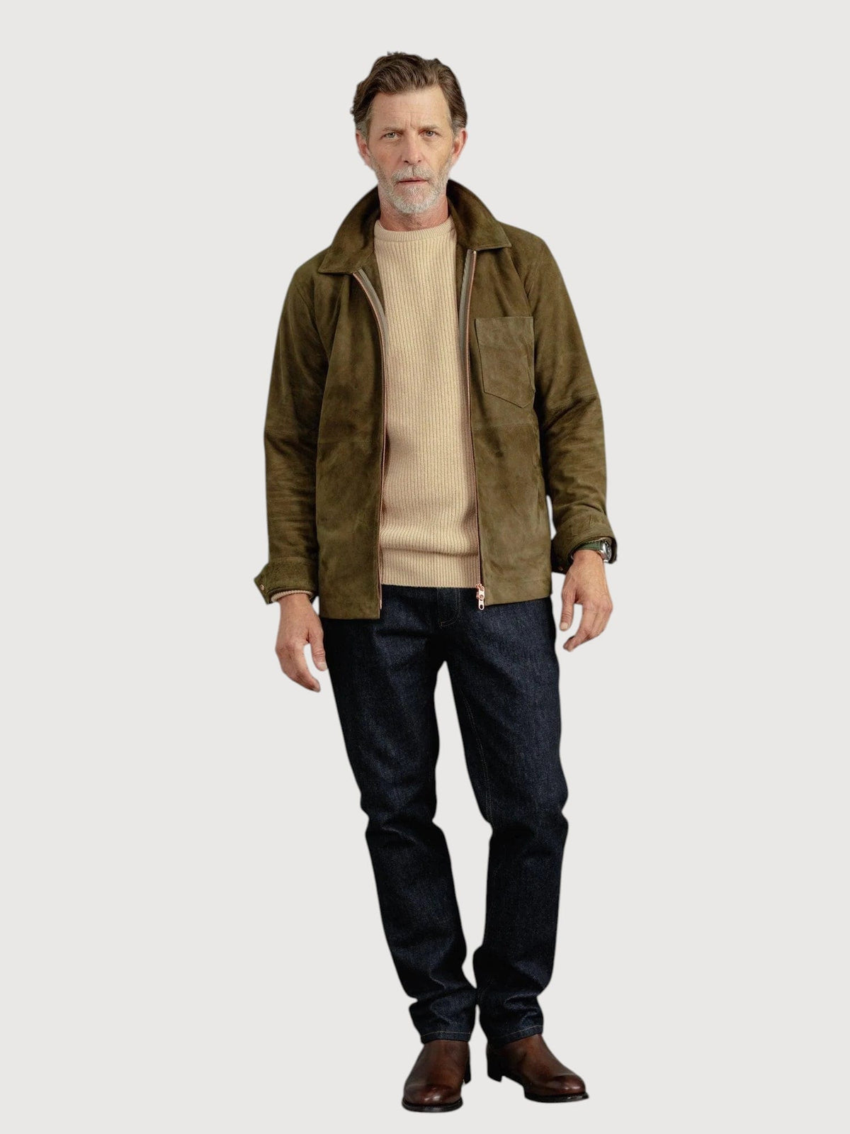 Luxequir Vogue moss green suede overshirt worn by a man with a beige sweater and dark denim jeans