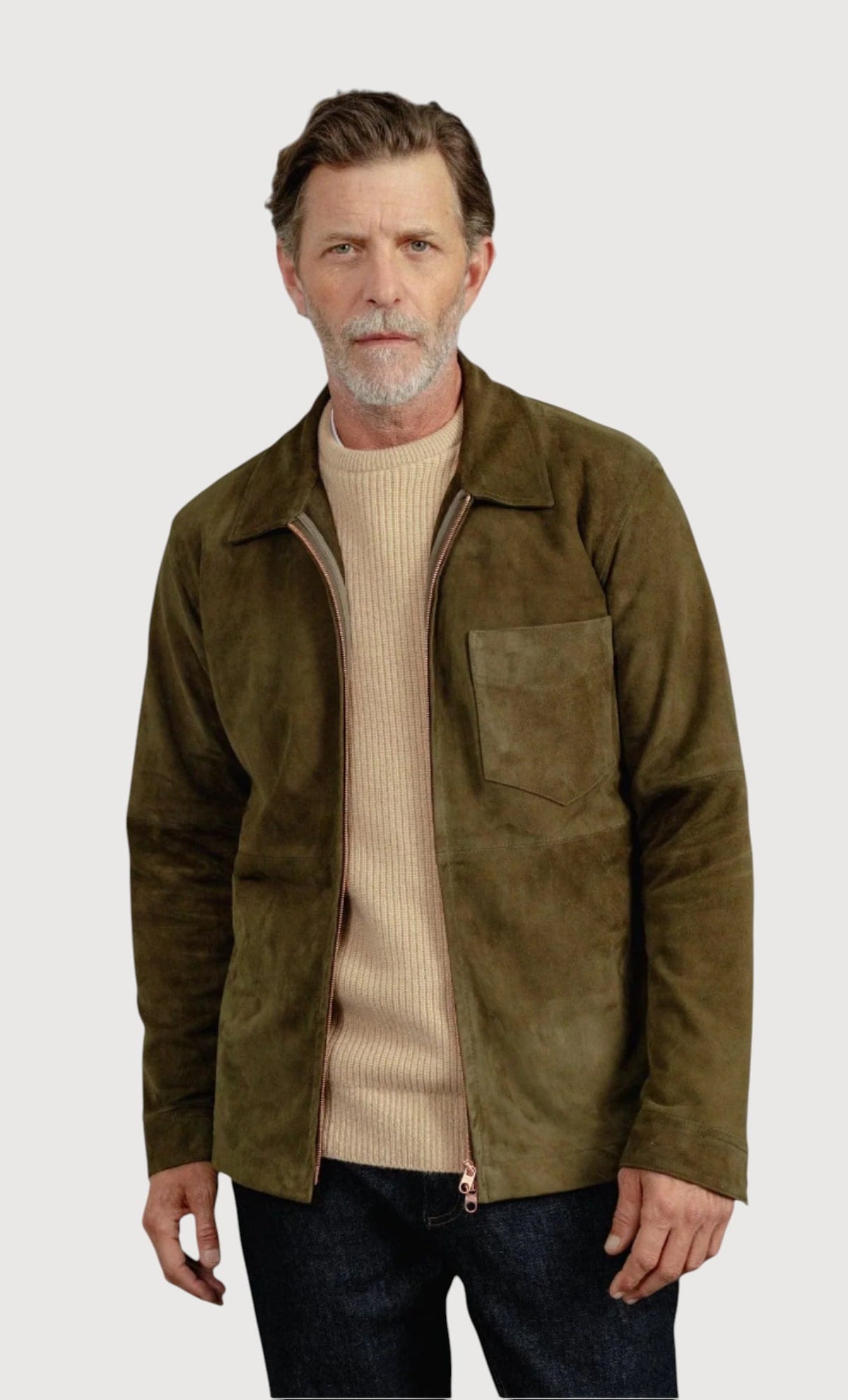 Luxequir Vogue moss green suede overshirt worn by a man over a beige sweater, featuring a front zip and chest pocket.
