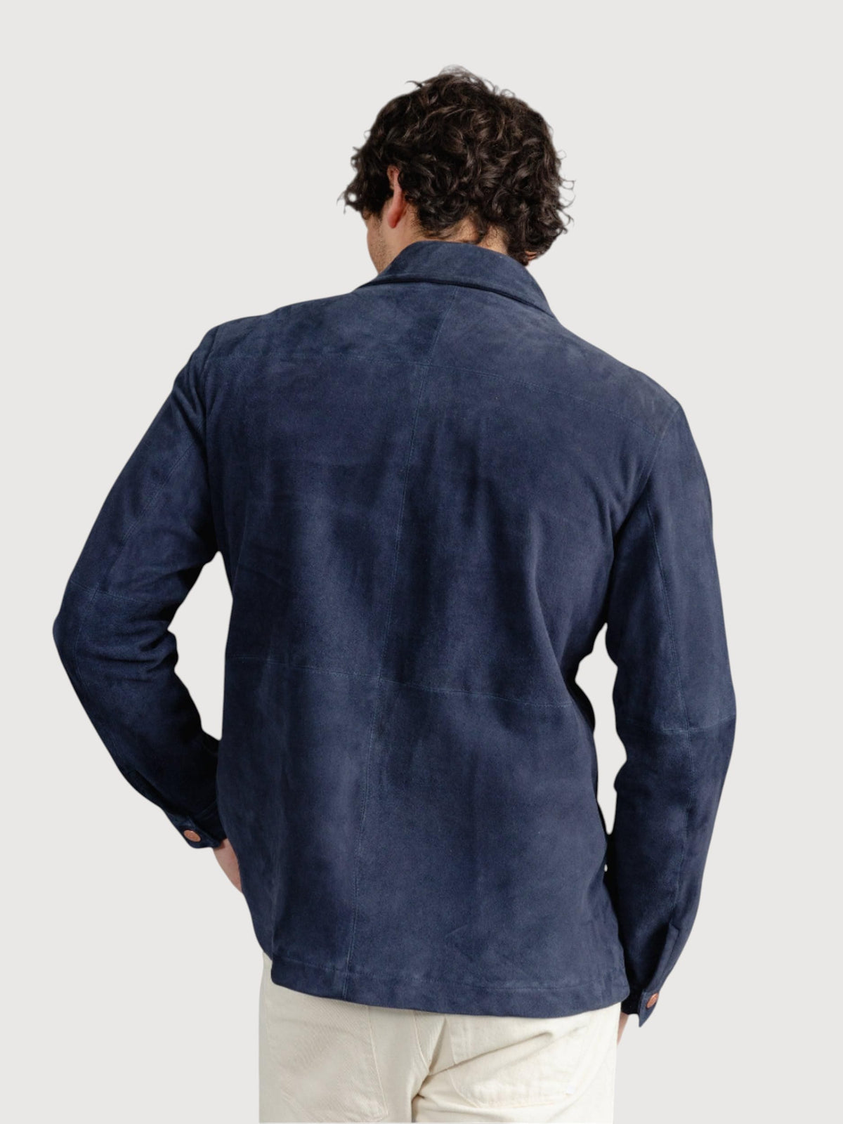 Back view of a man wearing a Luxequir Vogue navy blue suede panelled overshirt with a regular fit