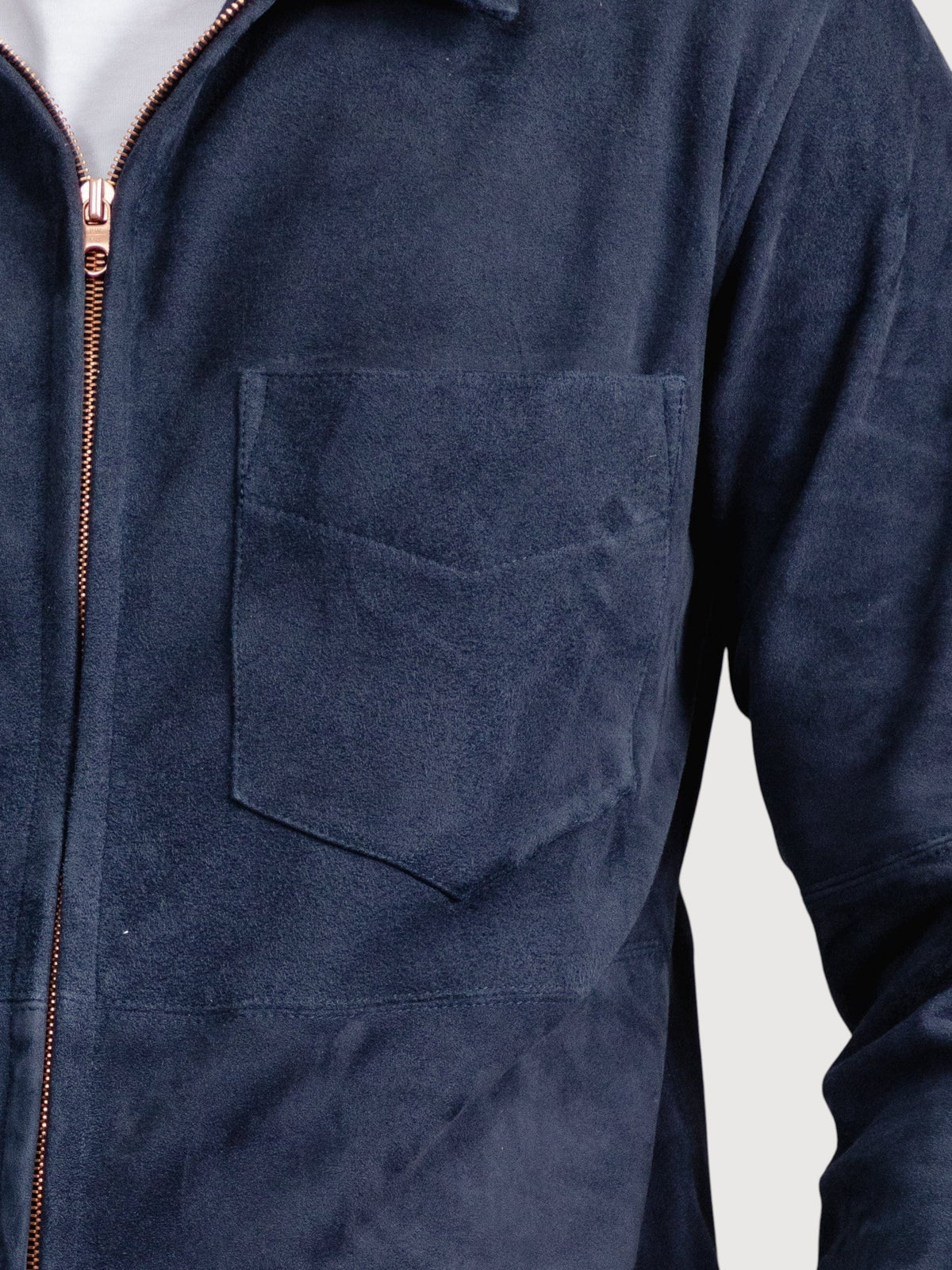 Luxequir Vogue navy suede overshirt featuring a chest pocket and a metallic front zipper closure.