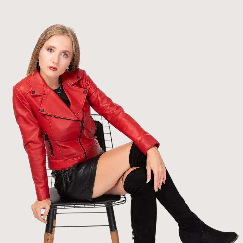 Luxequir Vogue red lambskin leather biker jacket with asymmetrical zipper worn by a model on a black wire chair