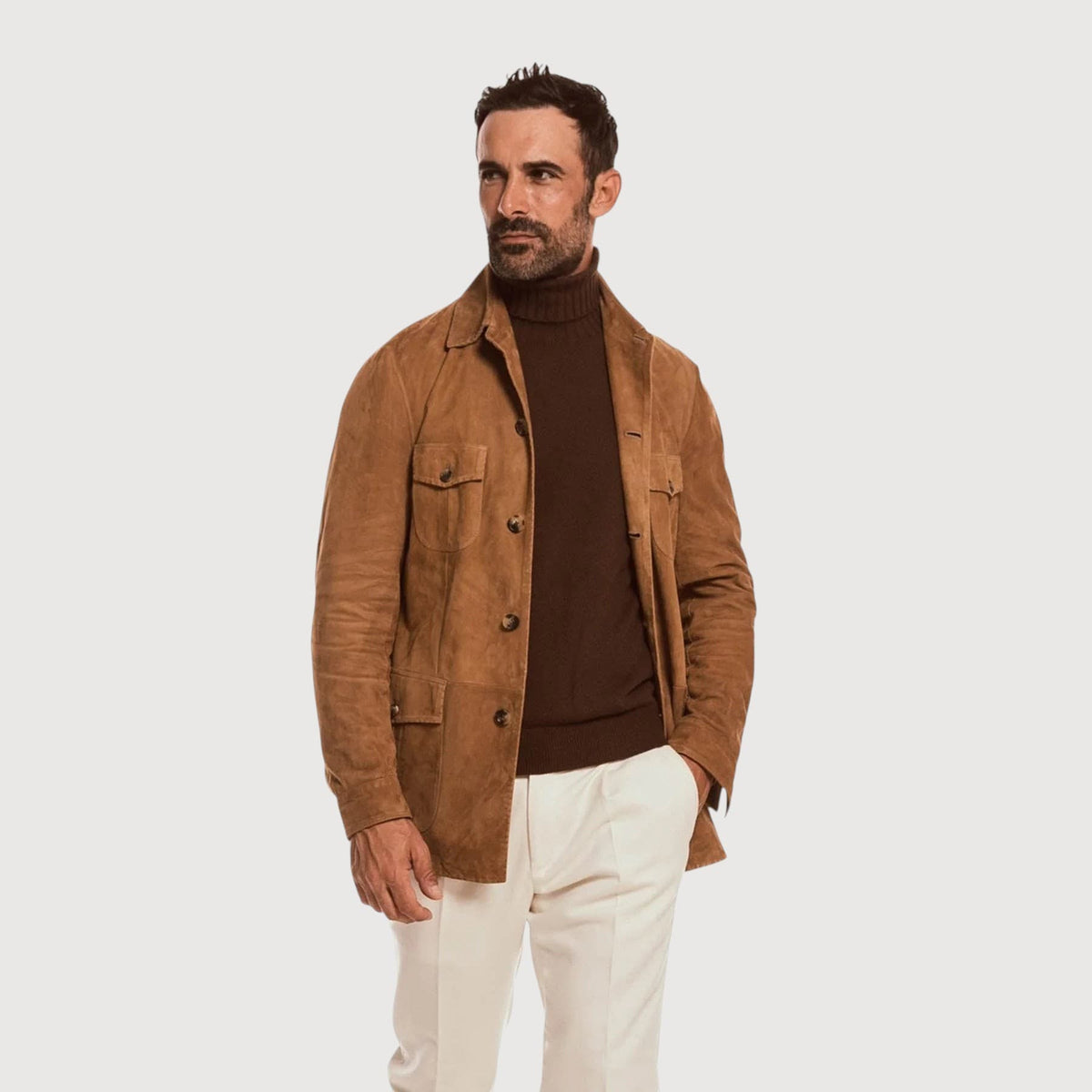 Luxequir Vogue handmade tan reverse suede safari jacket with four pockets and button closure worn by a man